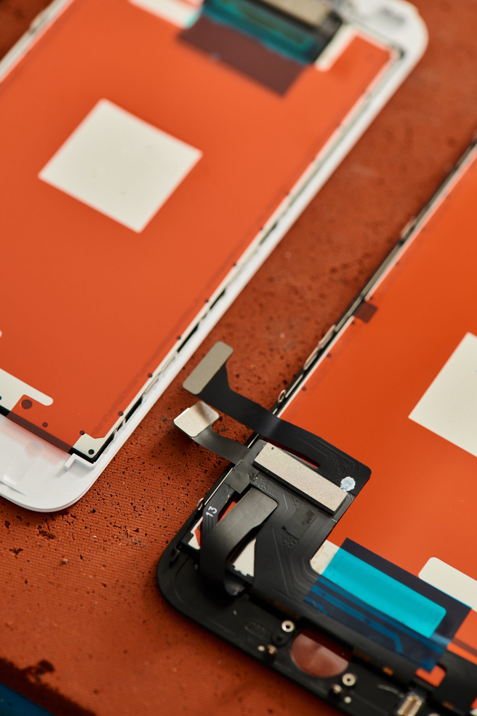 top view of disassembled smartphones on table in workshop electronic maintenance business concept